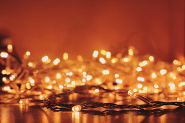 New Year's garland lights are lit with yellow light. New year bokeh