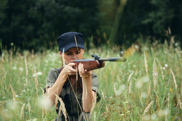 Woman soldier Shelter in the grass hunting weapon green leaves