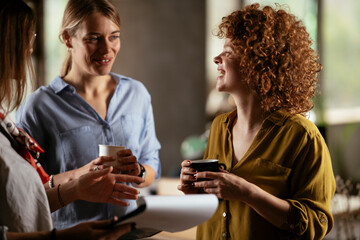 Colleagues in office talking and having fun. Friends working together.