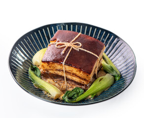 Isolated Dong Po Rou (Dongpo pork meat) in a beautiful plate with green vegetable.