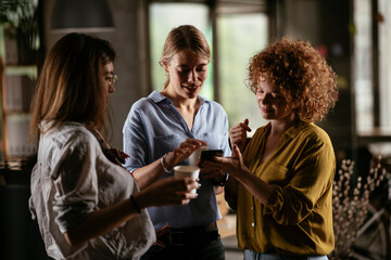 Colleagues in office talking and having fun. Friends working together.