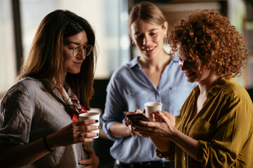 Colleagues in office talking and having fun. Friends working together.