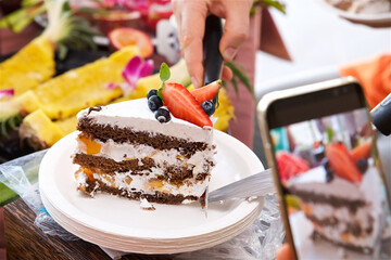 party table, strawberry and blueberry sponge cake, tropical fruits, sliced papaya, watermelon, pineapple and passion fruit, vegetarian and vegan food