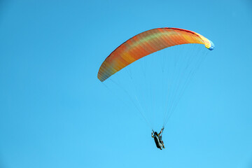 Exercises of paragliding athletes in the hills
