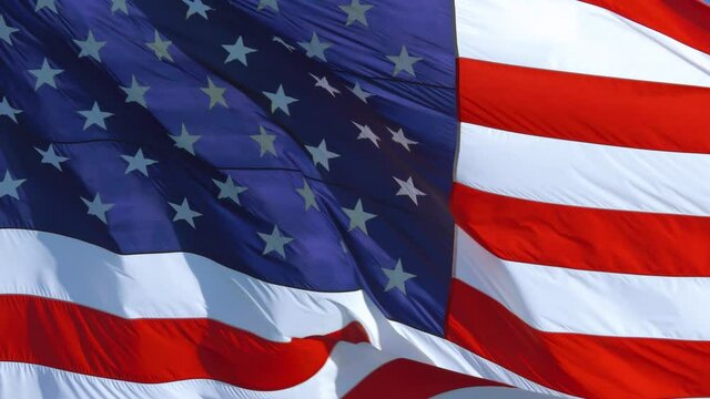 FULL SCREEN, 4K: American flag USA Close Up flies background texture. Close up of United States flag. 4k American flag is fluttering in wind. American national flag stars and stripes waving in wind