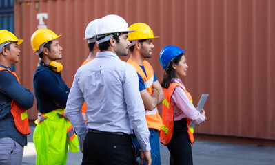 Group Portrait of Success Team of foreman and worker people arms crossed standing at container yard port of import and export. Business teamwork concept