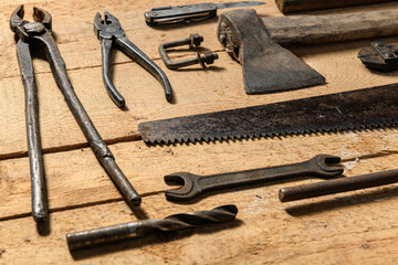 Variety of old vintage household hand tools still life on a wooden background in a DIY and repair concept