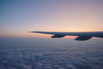 airplane wing in front of a beautiful sunrise