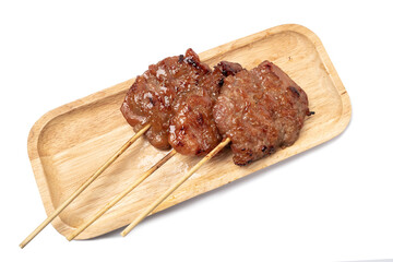 Thai grilled pork in a wooden plate isolated on white background.
