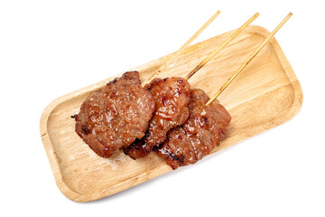 Thai grilled pork in a wooden plate isolated on white background.
