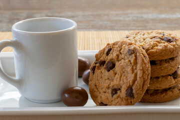 chocolate chip cookie and white cup. space for text