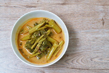 spicy boiled morning glory with fat pork in coconut milk curry or Kaeng The Po Thai food on bowl