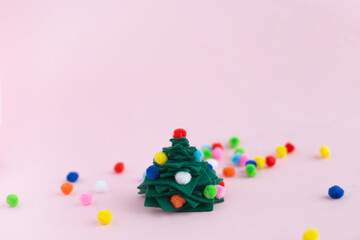 How to make small felt christmas tree at home. Step by step instructions. Hands making easy to follow DIY project. Step 8: place your small felt Christmas tree and celebrate