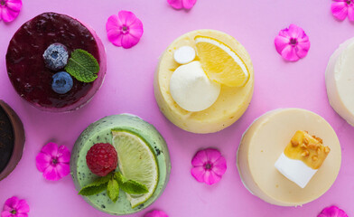 delicious cupcakes or mini cheese cake decorated with happy birthday theme