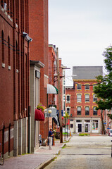 Romantic backstreet, side street or alley in historic old town of Portland, Maine with New England...