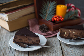 Chocolate Christmas Cake on dark background. Classic chocolate cake with dark chocolate and Christmas lights, sparklers