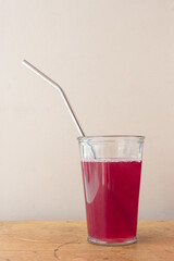 Juice in glass with metal straw