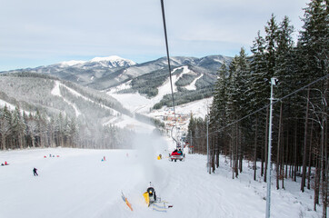 Fototapeta na wymiar Ski track with chair lift, Bukovel resort, Carpathian mountains, Ukraine