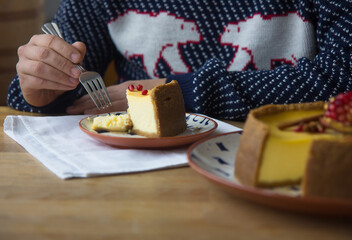 Cheesecake with berry in hands man . Tasty homemade caramel cheesecake