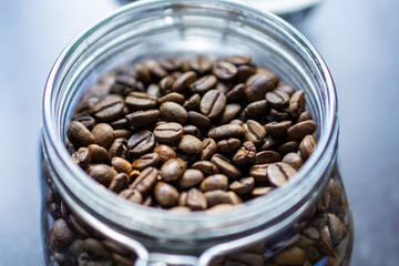 A closeup shot of roasted coffee beans in a glass container in Kandy, Sri Lanka