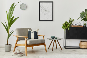 Modern retro concept of home interior with design grey armchair, coffee table, plants, mock up poster map, carpet and personal accessoreis. Stylish home decor of living room.