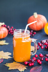 Halloween cocktail, pumpkin orange drink with spices. Dark vintage dirty background. Creative atmospheric decoration