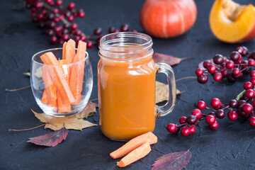 Halloween cocktail, pumpkin orange drink with spices. Dark vintage dirty background. Creative atmospheric decoration