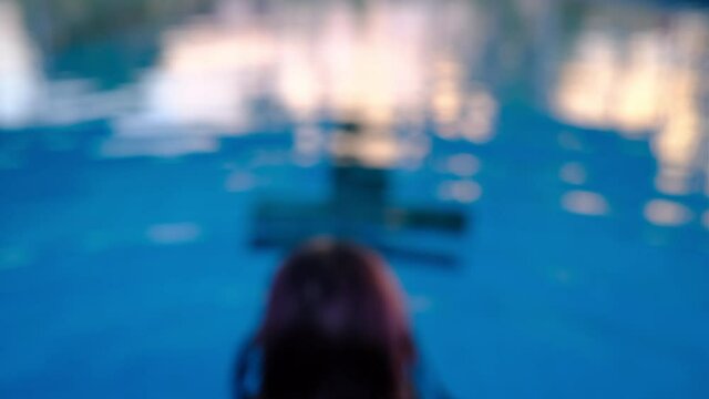 Defocused woman swimming in swimming pool