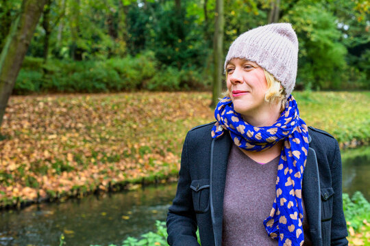 Blond Woman In Her 40s Walking In Park In Autumn