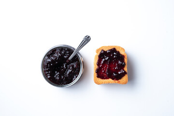 rusk and cherry jam on a white background. breakfast concept. Jar of jam with rusk