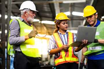 Professional Mechanical Engineer team Working on Personal Computer at Metal lathe industrial manufacturing factory. Engineer Operating  lathe Machinery. Product quality Inspection