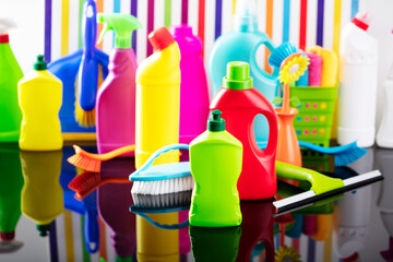 House and office cleaning theme. Colorful set of bottles with clining liquids on background in the form of colorful stripes.