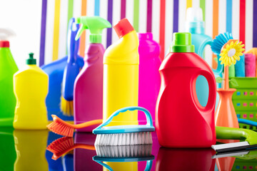 House and office cleaning theme. Colorful set of bottles with clining liquids on background in the form of colorful stripes.