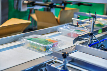 Box with food on conveyor belt in distribution warehouse. parcels transportation system concept