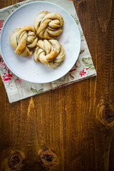 Fresh Swedish cardamom buns on a wooden background