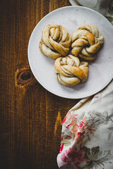 Fresh Swedish cardamom buns on a wooden background