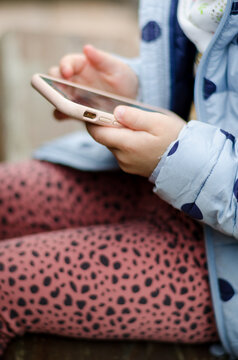 Kind drau&szlig;en mit Smartphone in der Hand