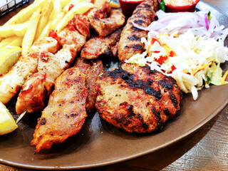 tasty kabobs grilled meat and vegetables skewers on a slate plate