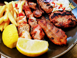 tasty kabobs grilled meat and vegetables skewers on a slate plate