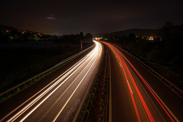 Fototapeta na wymiar Overhaul with red car light trails on a motorway in night
