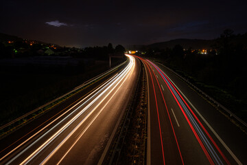 Fototapeta na wymiar Many light trails in night of cars and trucks