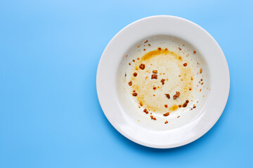 Dirty dish on blue background. Top view