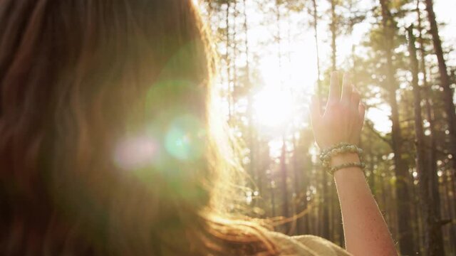 spirituality and supernatural concept - young woman or witch performing magic ritual in forest