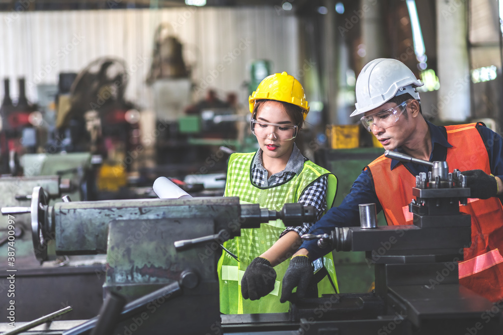 Wall mural professional operators team engineer woman and man worker at industrial factory wearing uniform and 