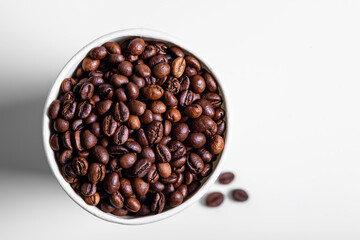 roasted coffee beans in white paper Cup on white background