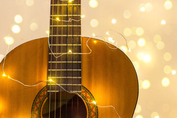 acoustic guitar wrapped in a luminous garland. Christmas gift