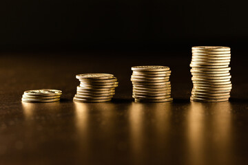 Stacks of gold coins with dark background