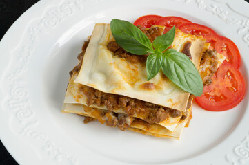 Meat lasagna with basil.