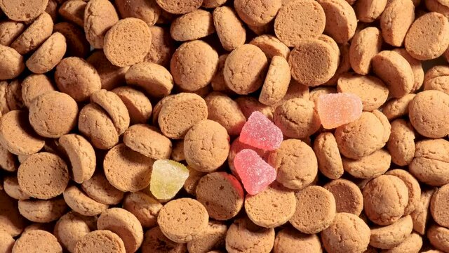 Saint nicholas is throwing traditional cookies for Dutch holiday Sinterklaas. Kruidnoten, sweets, strooigoed. St. Nicolas day concept. 4K video, 50 fps