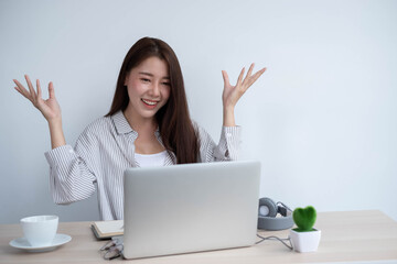 asian female use laptop computer and video call with friend in home, work from home concept.
